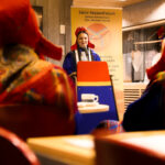 a Sámi woman in traditional clothing having a speech.