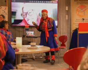 a Sámi woman in traditional clothing having a speech.